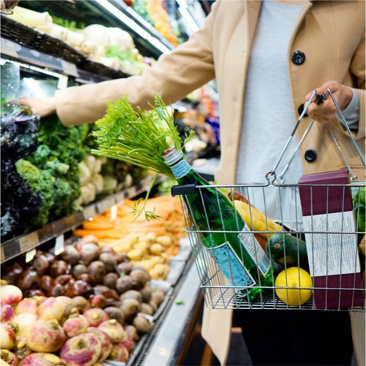 Woman shopping in grocery store produce section